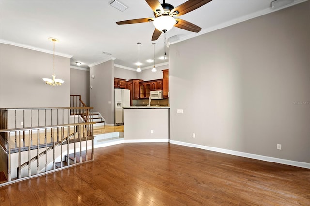 empty room featuring crown molding, light hardwood / wood-style flooring, and ceiling fan with notable chandelier