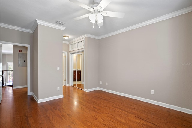 spare room featuring ornamental molding, dark hardwood / wood-style floors, and ceiling fan