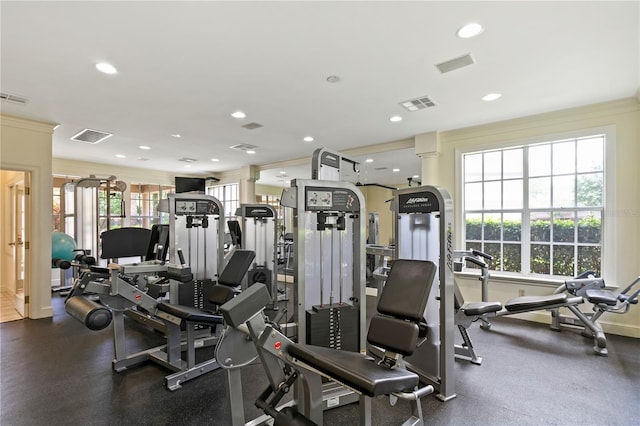 exercise room featuring ornate columns and ornamental molding