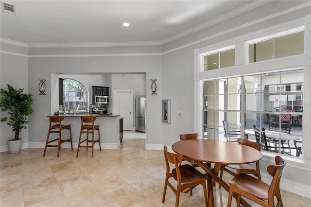 dining room featuring crown molding