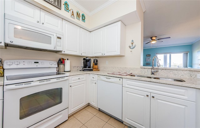 kitchen featuring white cabinetry, sink, light tile patterned floors, crown molding, and white appliances