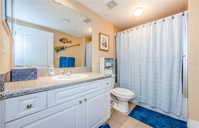 full bathroom with tile patterned flooring, shower / bath combo, vanity, and toilet