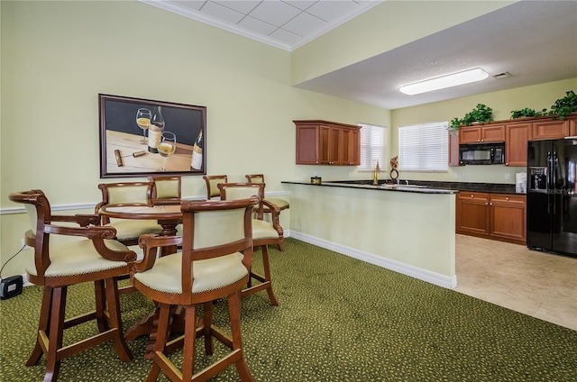 kitchen featuring crown molding and black appliances