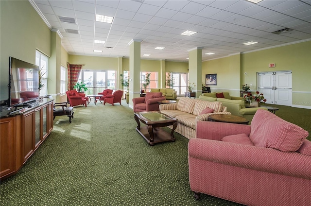 carpeted living room featuring crown molding and a paneled ceiling