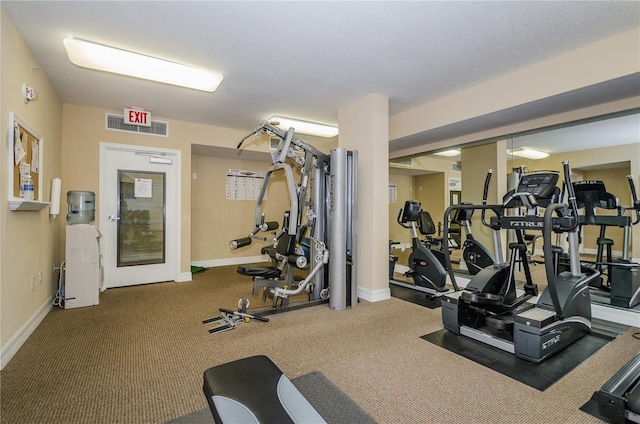 gym featuring dark colored carpet