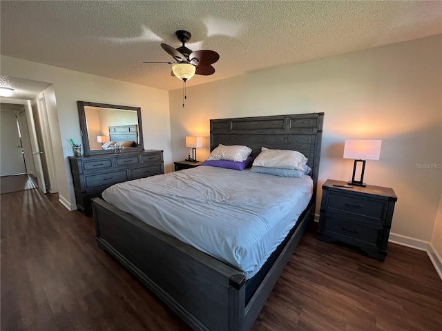 bedroom featuring ceiling fan, dark hardwood / wood-style floors, and a textured ceiling