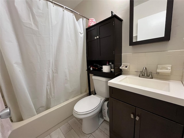 full bathroom featuring vanity, shower / bath combo, and toilet