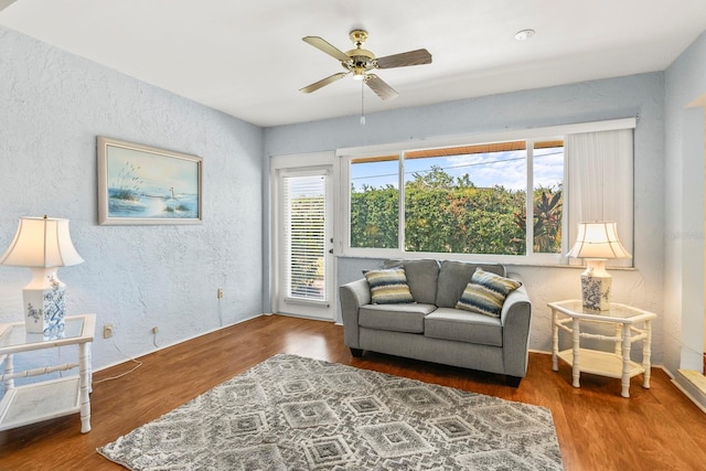 sitting room with hardwood / wood-style floors, plenty of natural light, and ceiling fan