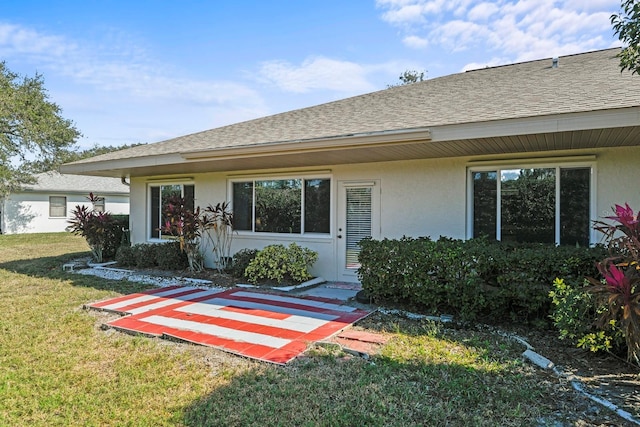 rear view of house featuring a yard