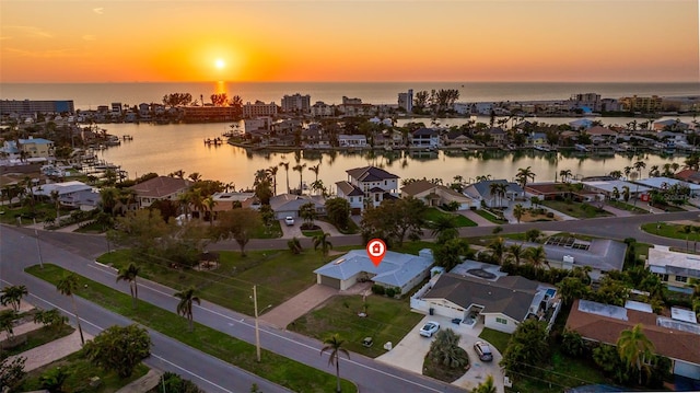 aerial view at dusk with a water view