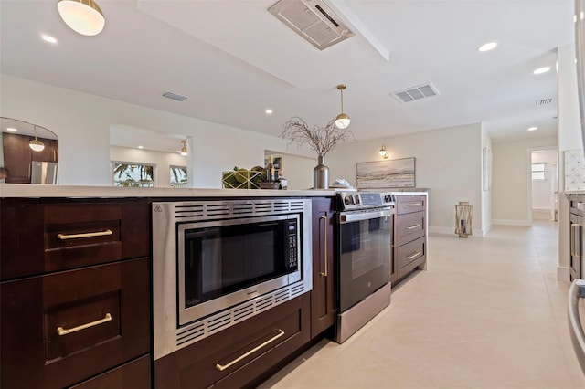 kitchen with dark brown cabinetry, appliances with stainless steel finishes, and hanging light fixtures