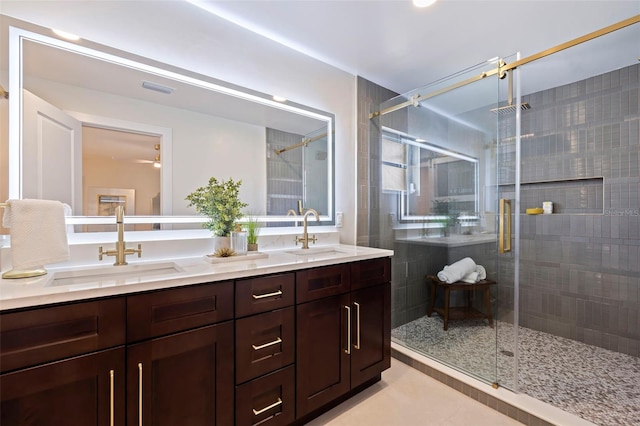 bathroom featuring a shower with door, vanity, and tile patterned flooring