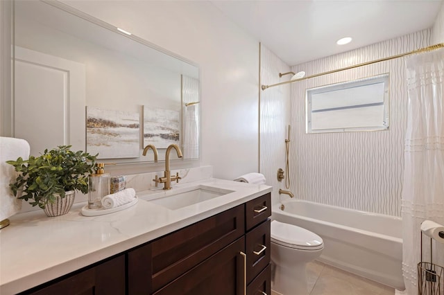 full bathroom featuring tiled shower / bath combo, vanity, tile patterned flooring, and toilet