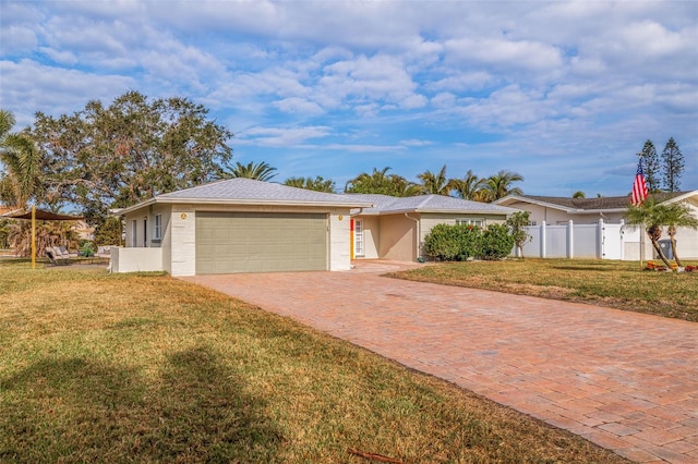 ranch-style home featuring a garage and a front yard