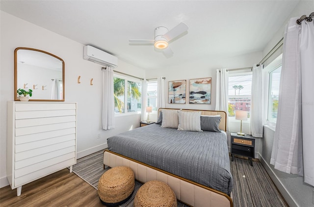 bedroom with multiple windows, dark wood-type flooring, a wall mounted AC, and ceiling fan