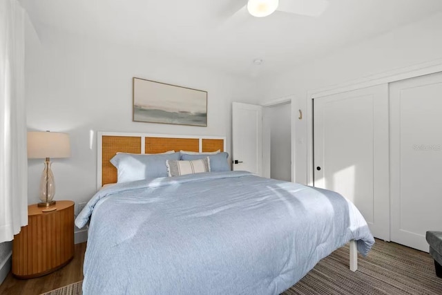 bedroom featuring hardwood / wood-style flooring, ceiling fan, and a closet