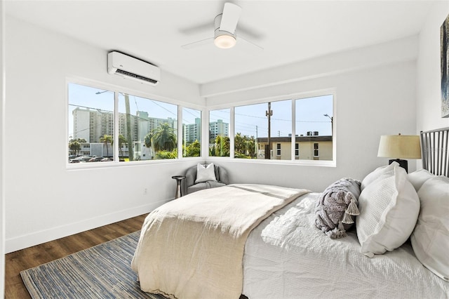 bedroom featuring dark hardwood / wood-style floors, an AC wall unit, and ceiling fan