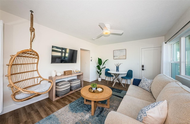 living room with ceiling fan, hardwood / wood-style floors, and a textured ceiling