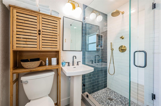 bathroom featuring an enclosed shower and toilet