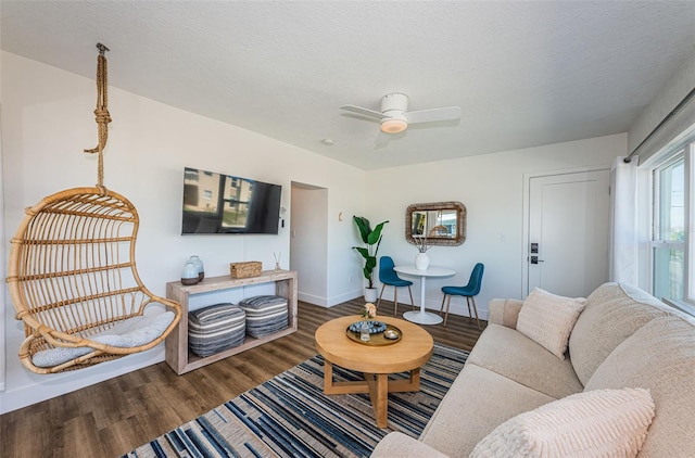 living room featuring hardwood / wood-style floors, a textured ceiling, and ceiling fan