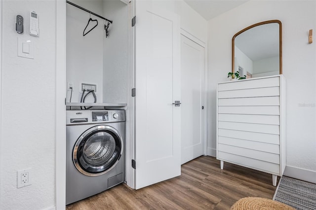 washroom featuring dark wood-type flooring and washer / dryer