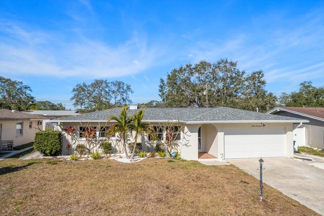 single story home featuring a garage and a front yard