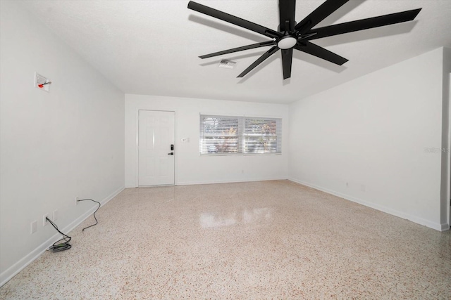 spare room featuring a textured ceiling and ceiling fan