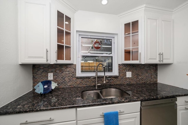 kitchen with sink, black dishwasher, white cabinets, dark stone counters, and backsplash