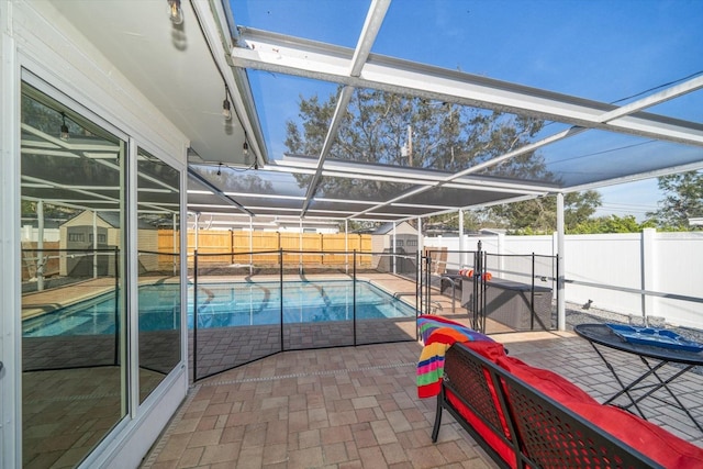 view of swimming pool featuring a patio, glass enclosure, and a storage shed