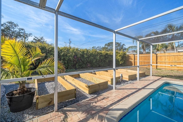 view of pool with a fenced in pool, a patio, glass enclosure, and fence