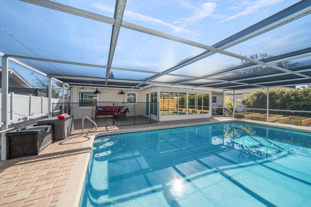 outdoor pool featuring a patio, a lanai, and fence