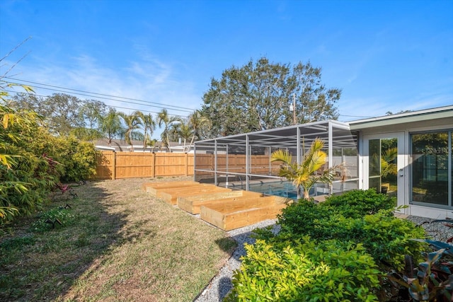 view of yard with a fenced in pool and a lanai