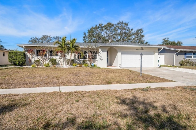 ranch-style house featuring a garage and a front yard