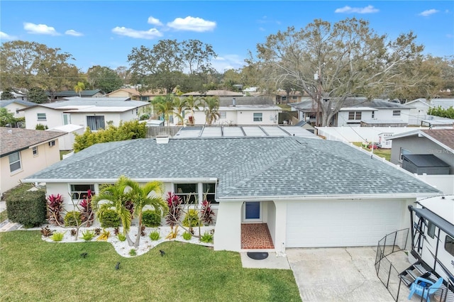 single story home featuring a residential view, a garage, concrete driveway, and roof with shingles