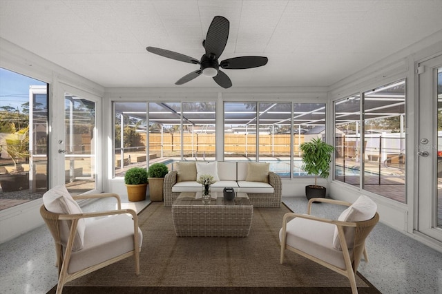 sunroom / solarium featuring a healthy amount of sunlight and a ceiling fan