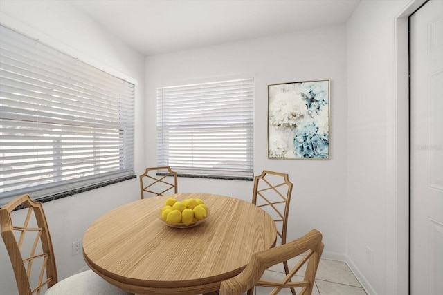 dining area featuring baseboards and light tile patterned flooring