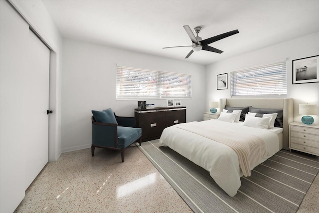 bedroom featuring speckled floor, a closet, and ceiling fan