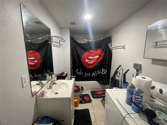 bathroom featuring shower / tub combination, vanity, washer and clothes dryer, and tile patterned flooring