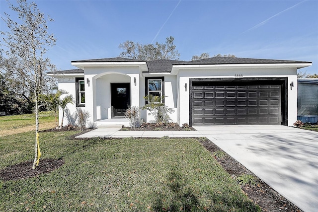 view of front of property featuring a garage and a front lawn