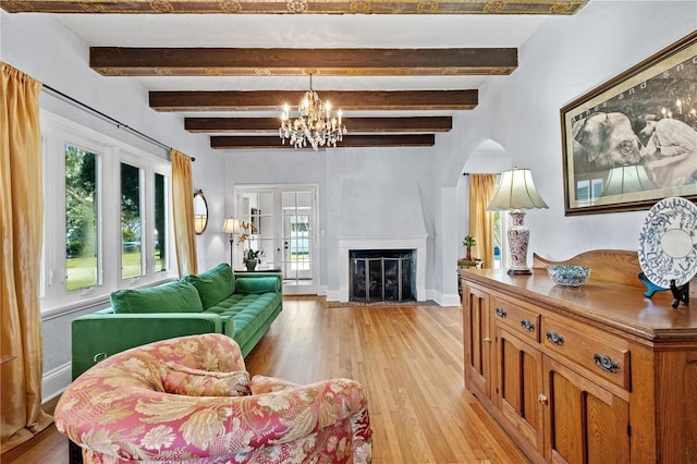 6010 17th Ave S, Gulfport, FL 33707 - living room featuring a notable chandelier, beam ceiling, and light wood-type flooring
