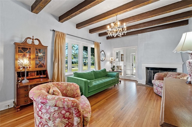 6010 17th Ave S, Gulfport, FL 33707 - living room featuring beam ceiling, wood-type flooring, and an inviting chandelier