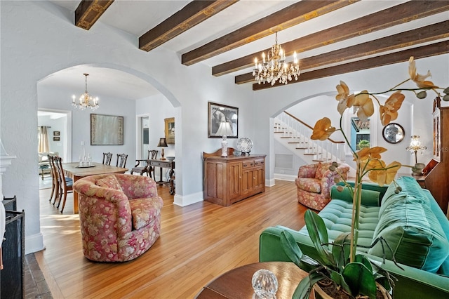 6010 17th Ave S, Gulfport, FL 33707 - living room featuring a notable chandelier, beam ceiling, and light hardwood / wood-style flooring