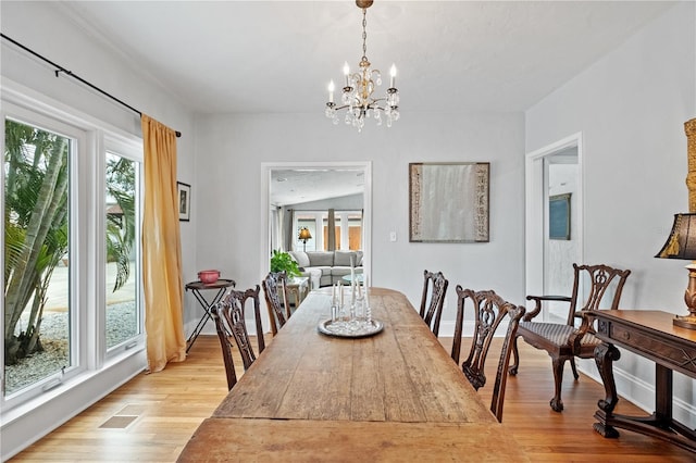 6010 17th Ave S, Gulfport, FL 33707 - dining space with light hardwood / wood-style flooring and a chandelier