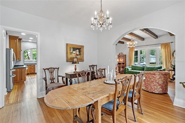 6010 17th Ave S, Gulfport, FL 33707 - dining area with beam ceiling, a chandelier, and light hardwood / wood-style flooring