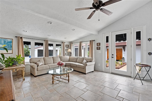 6010 17th Ave S, Gulfport, FL 33707 - living room with ceiling fan, plenty of natural light, vaulted ceiling with beams, and a textured ceiling