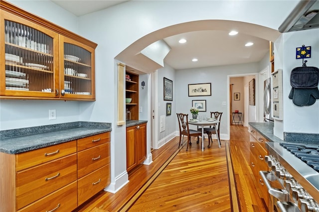 6010 17th Ave S, Gulfport, FL 33707 - kitchen with built in features, high end stainless steel range, and light hardwood / wood-style floors