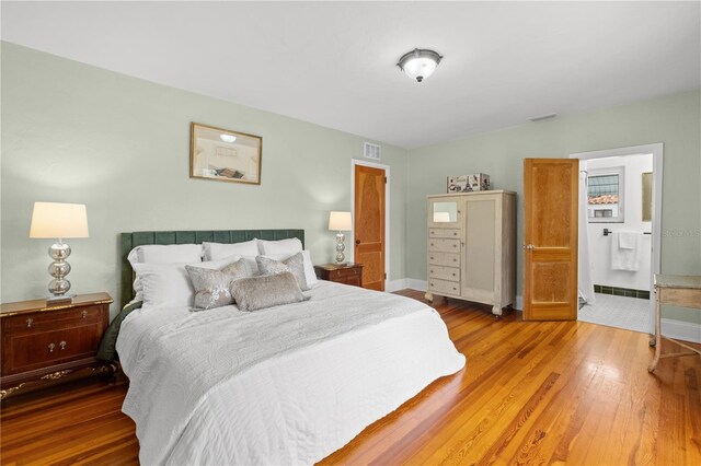 6010 17th Ave S, Gulfport, FL 33707 - bedroom featuring hardwood / wood-style flooring and ensuite bathroom
