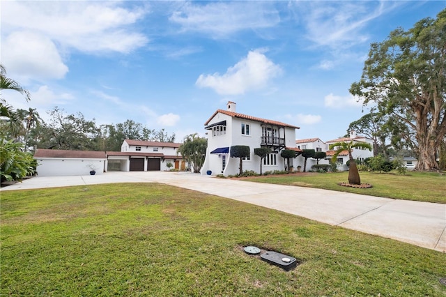 6010 17th Ave S, Gulfport, FL 33707 - mediterranean / spanish home featuring a garage and a front yard