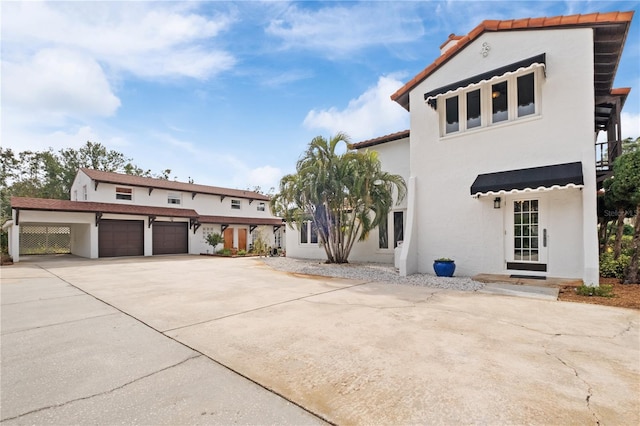 6010 17th Ave S, Gulfport, FL 33707 - mediterranean / spanish house featuring a garage