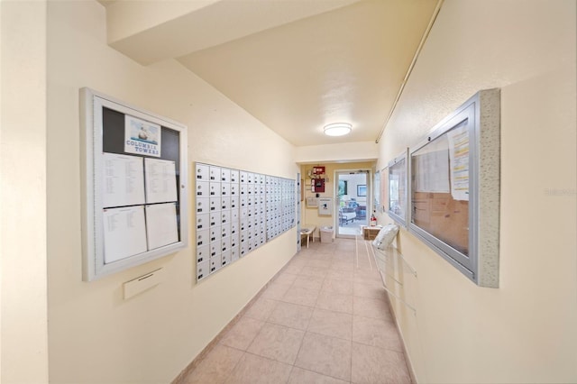 corridor featuring a mail area and light tile patterned flooring